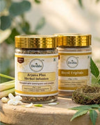 Two jars of Deshla herbal products on a wooden surface with greenery in the background