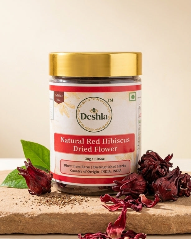 Jar of Deshla Natural Red Hibiscus Dried Flower on a wooden surface with hibiscus flowers.