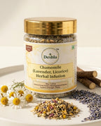 Jar of Deshla Chamomile Lavender Licorice Herbal Infusion with herbs and flowers on a white plate.