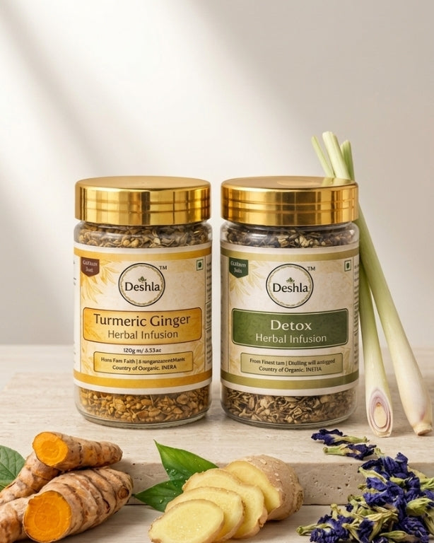Two jars of Deshla herbal infusions with turmeric and ginger on a wooden surface.