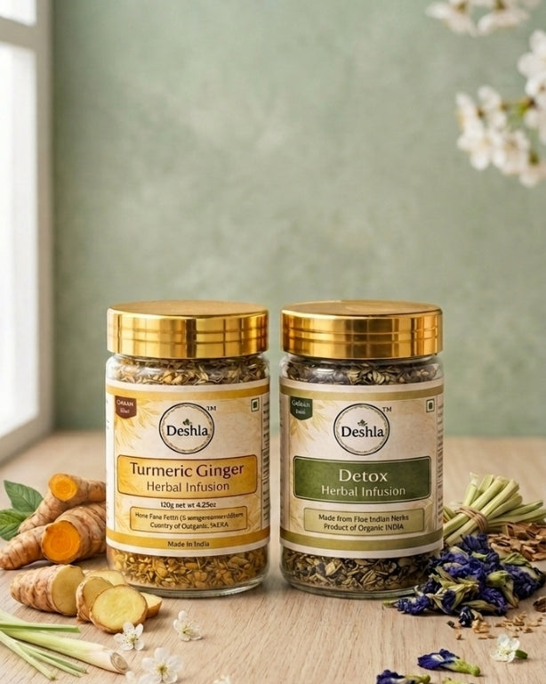 Two jars of Deshla herbal infusions on a wooden surface with natural ingredients.